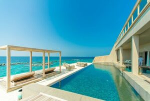 Gray outdoor lounge with a swimming pool on a beachside